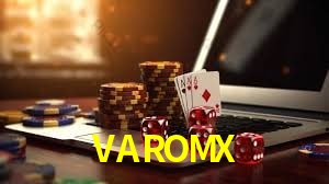 Una escena digital vívida inspirada en casino con VAROMX mostrado prominentemente, luces brillantes, fichas, cartas y acentos dorados.